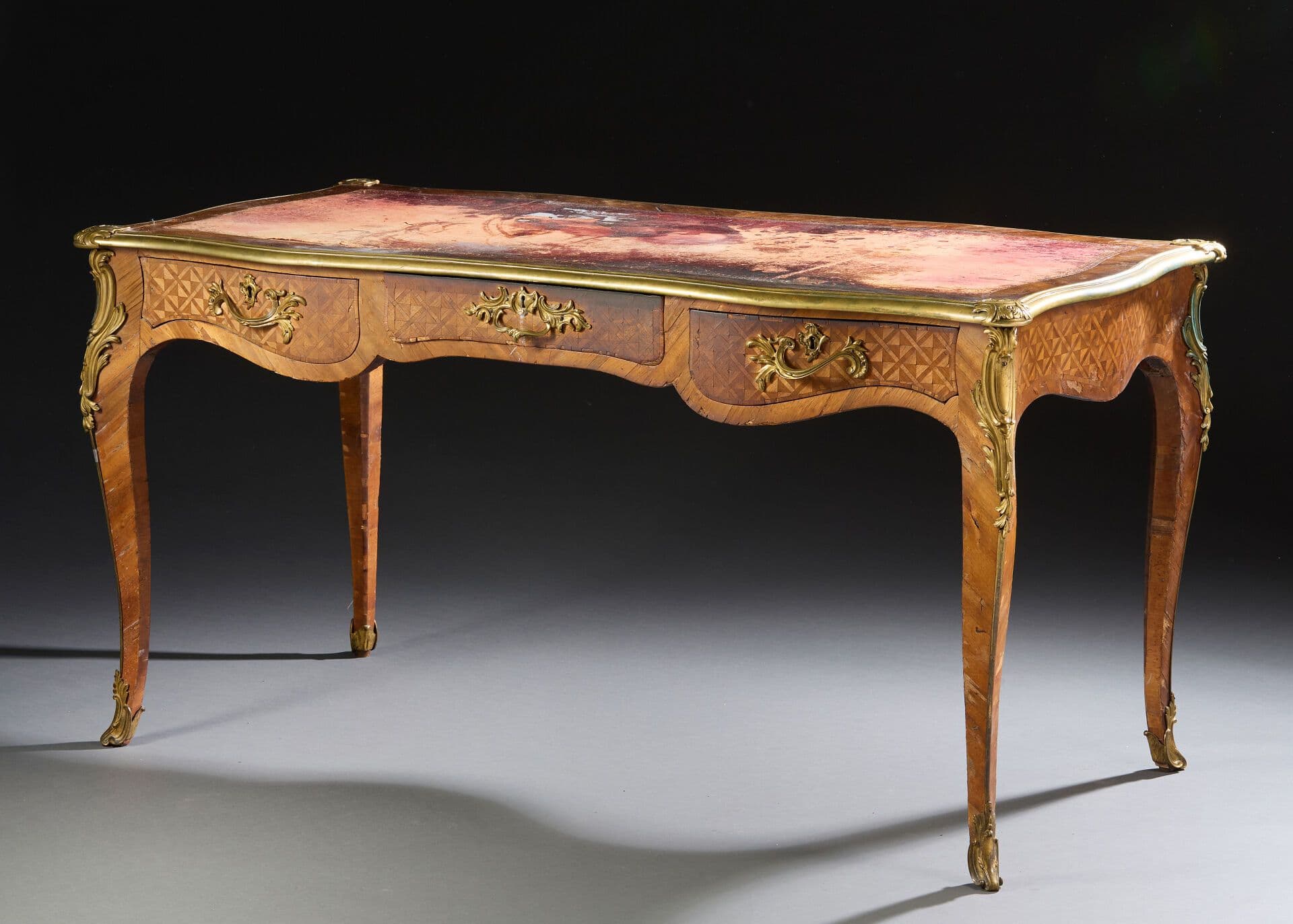 Bureau plat en placage de satiné à décor de marqueterie de croisillons.